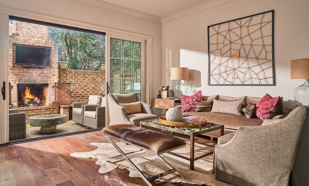 Cozy living room with view and access to back patio fireplace in luxury custom home by Simonini Homes in Charlotte, NC