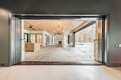 Indoor outdoor custom home patio view with stone fireplace and covered entertaining space in Waxhaw, NC by Simonini Homes-optimized