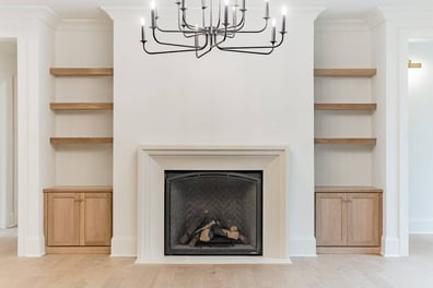 Living room fireplace with symmetrical shelving and wood cabinetry in a Simonini Homes custom home in Waxhaw, NC-optimized