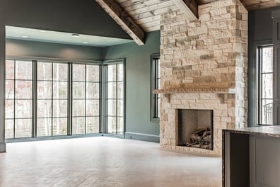 Open custom home space with natural light and stone fireplace in Waxhaw, NC by Simonini Homes-optimized