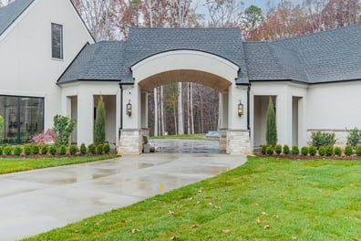 arched porte cochere on custom home by Simonini Homes in Waxhaw NC with landscaped entry-optimized