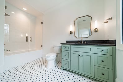 bathroom with green vanity and glass shower in Simonini Homes custom home Waxhaw, NC-optimized