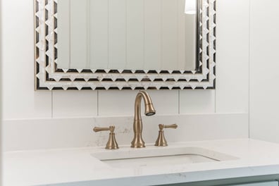 detailed vanity with gold fixtures and patterned mirror in Simonini Homes custom home Waxhaw, NC-optimized