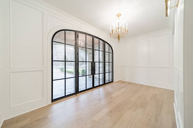 elegant dining space with hardwood floors and arched glass doors in a Simonini Homes custom home in Waxhaw, NC-optimized