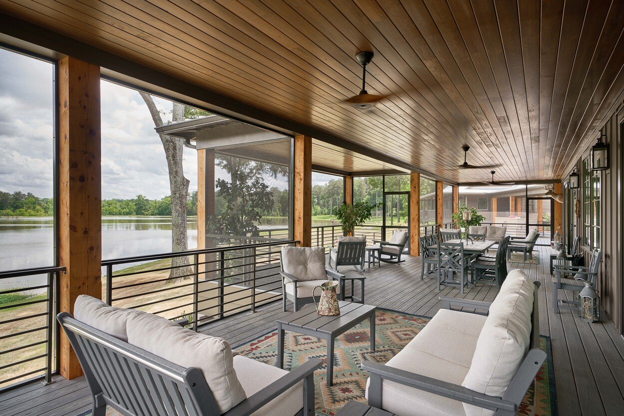 Covered lakefront porch with seating area at Custom Hunting Lodge in Fort Lawn, NC by Simonini Homes-1
