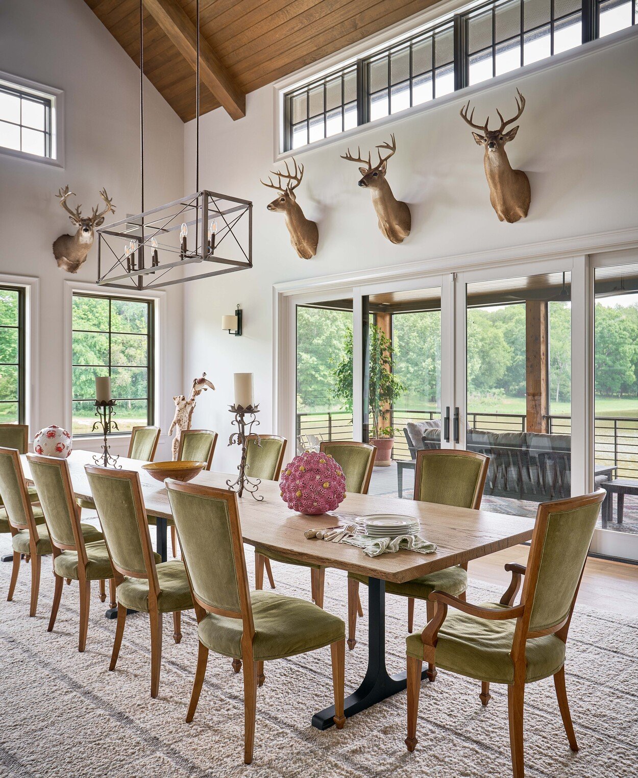 Grand dining area with mounted deer and scenic views at Custom Hunting Lodge in Fort Lawn, NC by Simonini Homes-1