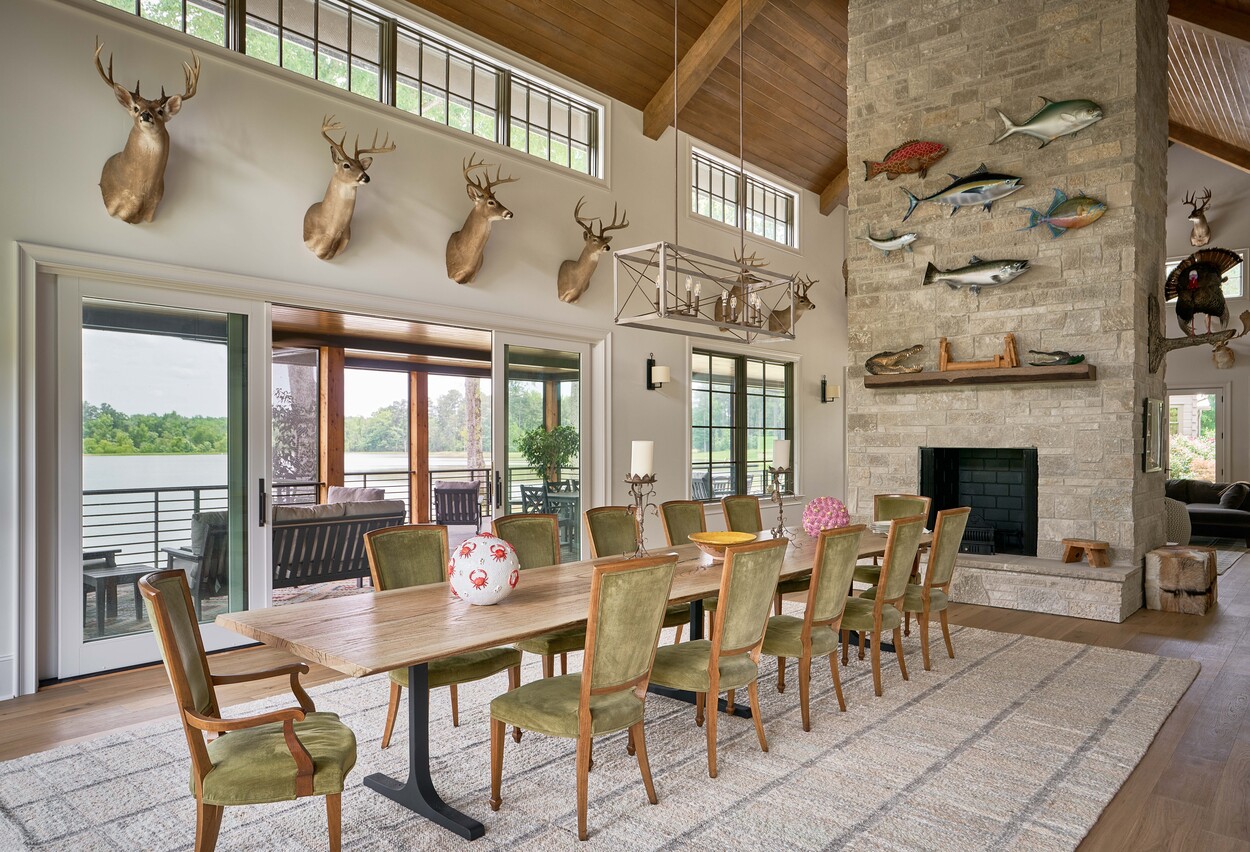 Lakeview dining room with fireplace and mounted fish display at Custom Hunting Lodge in Fort Lawn, NC by Simonini Homes-1