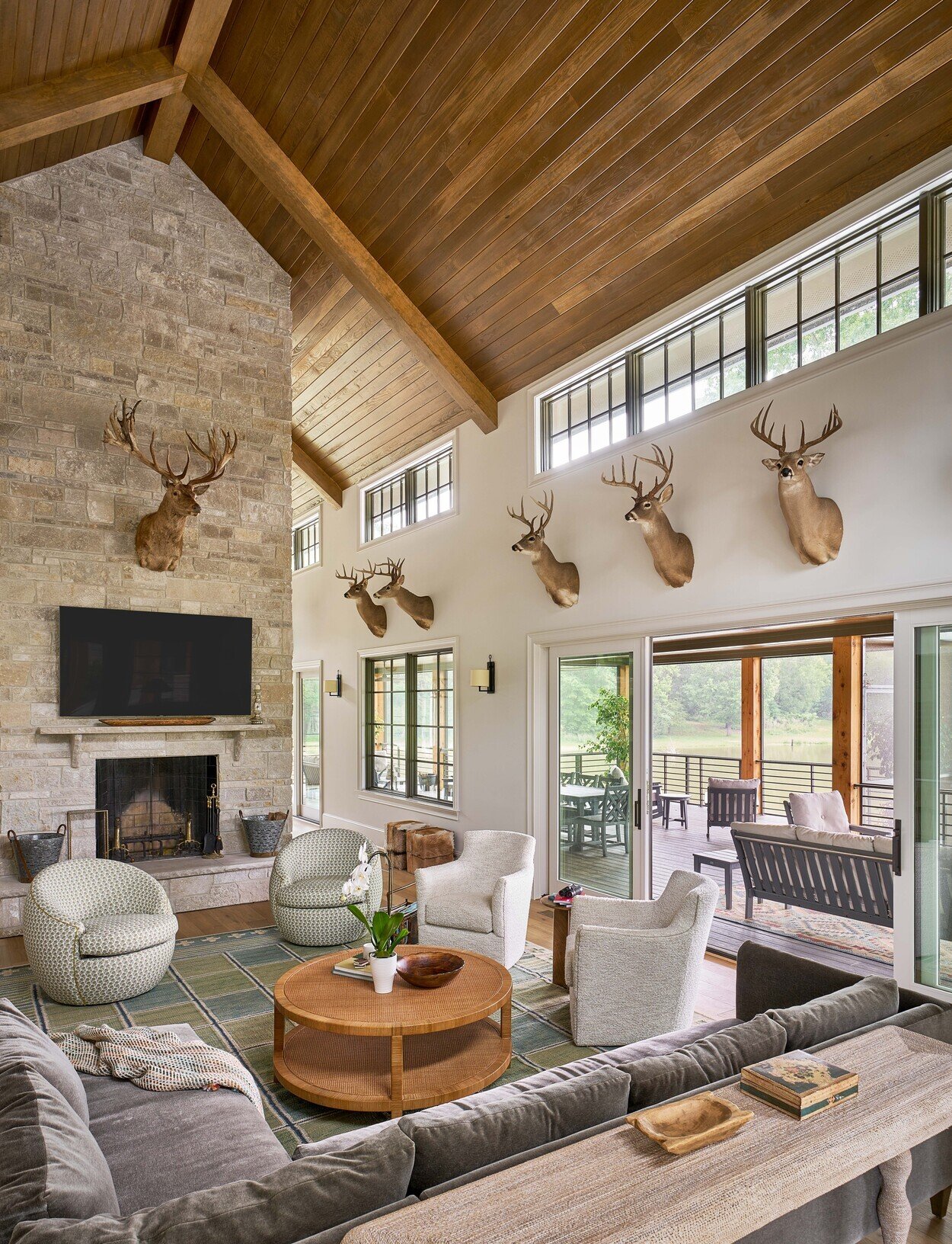 Luxurious great room with rustic accents and open lake view at Custom Hunting Lodge in Fort Lawn, NC by Simonini Homes-1