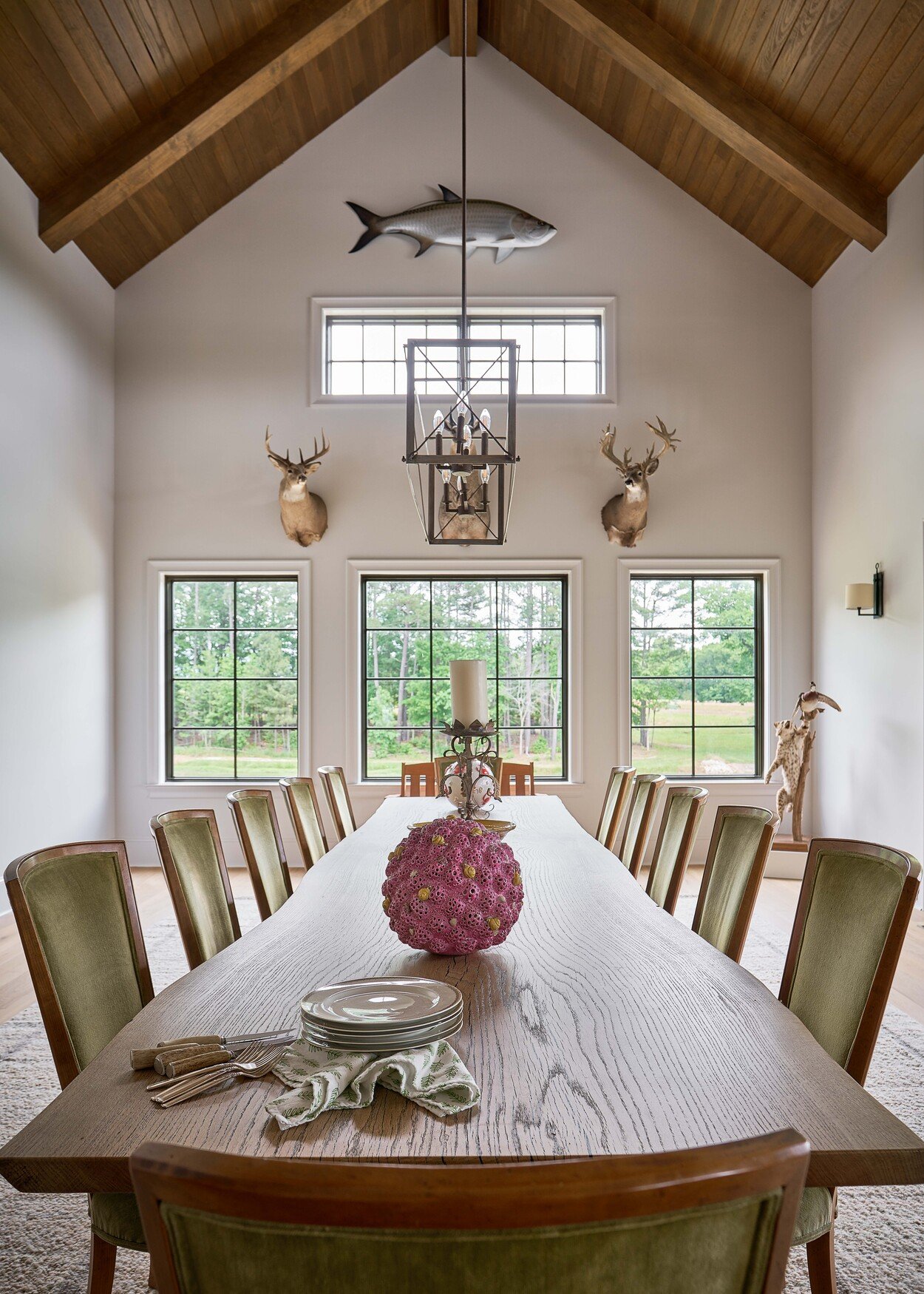 Vaulted dining room featuring rustic chandelier and wall mounts at Custom Hunting Lodge in Fort Lawn, NC by Simonini Homes-1