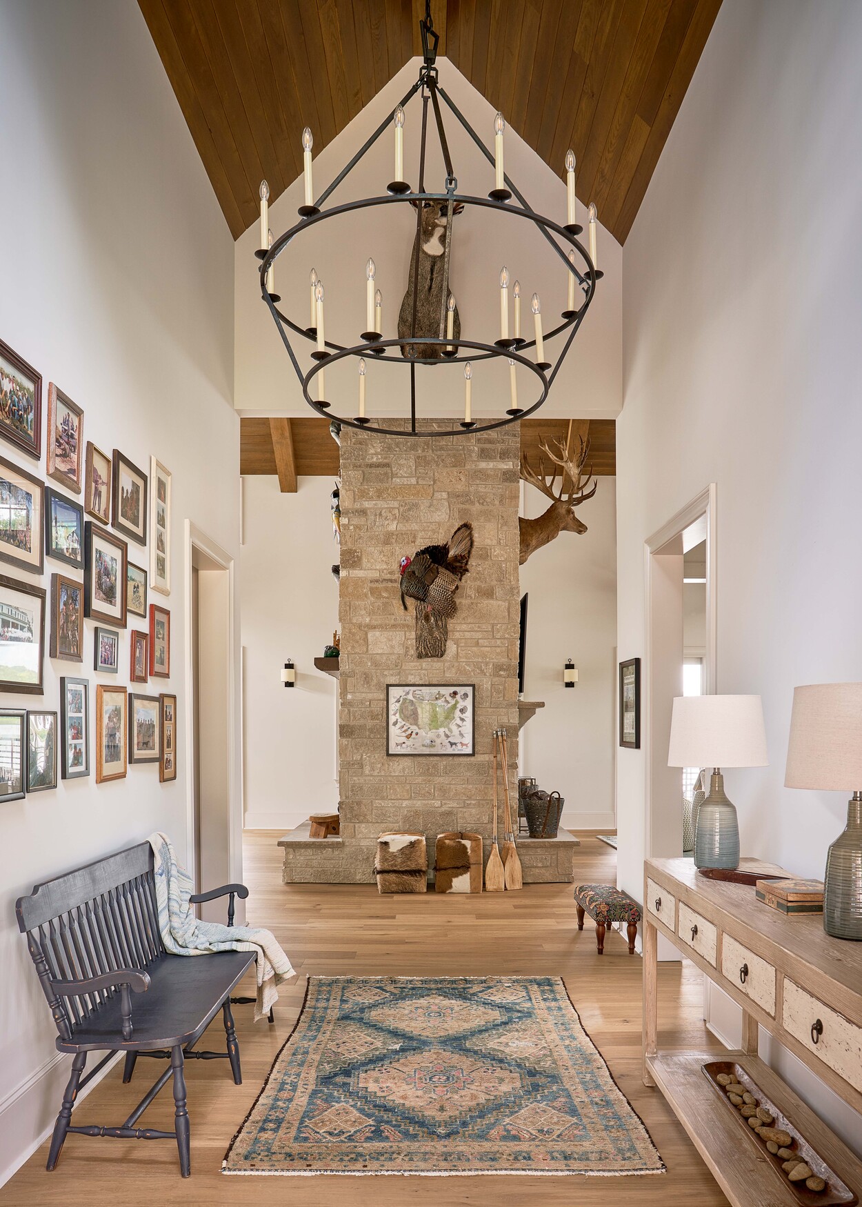 Welcoming hallway features rustic chandelier and wood accents at Custom Hunting Lodge in Fort Lawn, NC by Simonini Homes-1